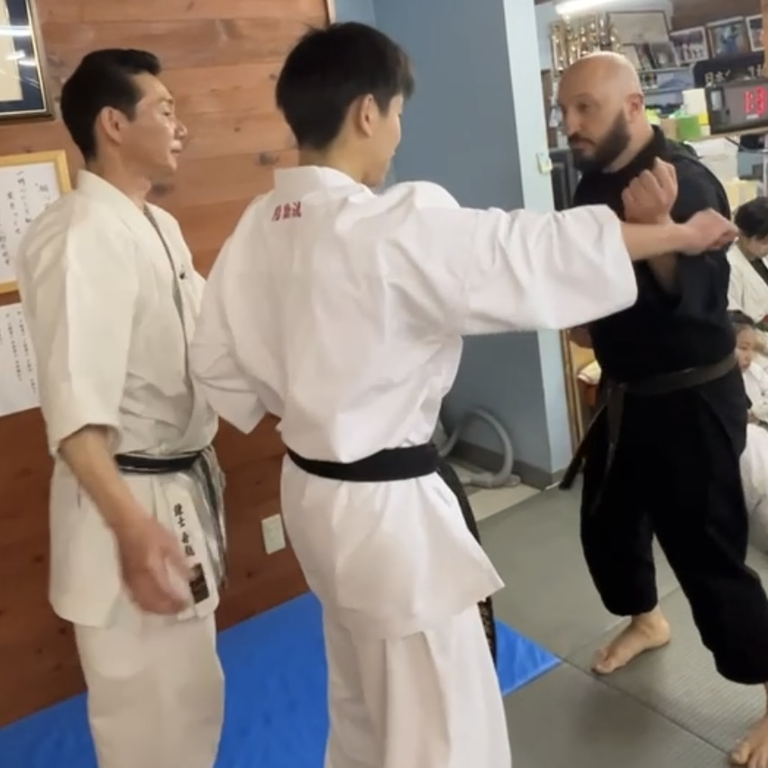 Olgun Tiltay in Ichinomiya Japan doing conditioning with Funakoshi Masaharu Sensei [8th Dan Karate of Nahate Origin]